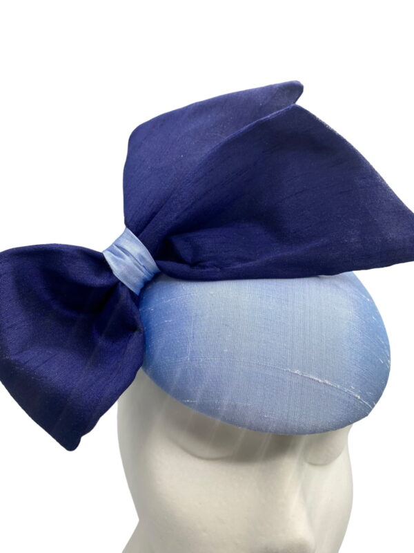 Stunning steel baby blue raw silk base headpiece with a beautiful raw silk navy side bow to finish.